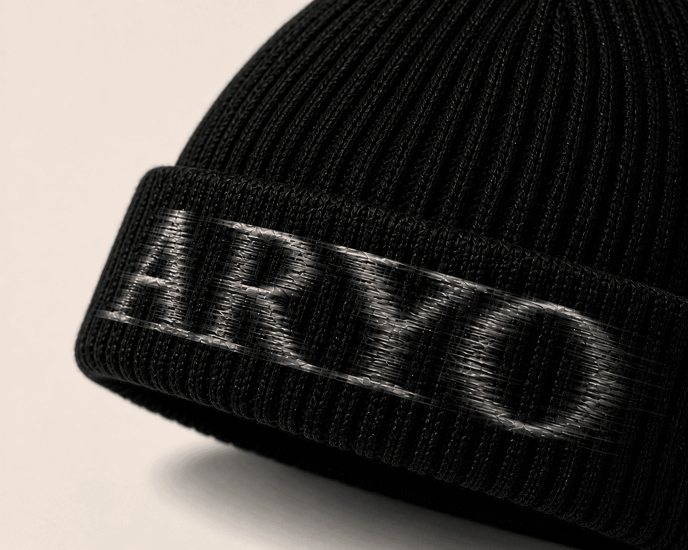 Gozar ARYO Beanie in Noir, directional silver-graphite wordmark and rib detail