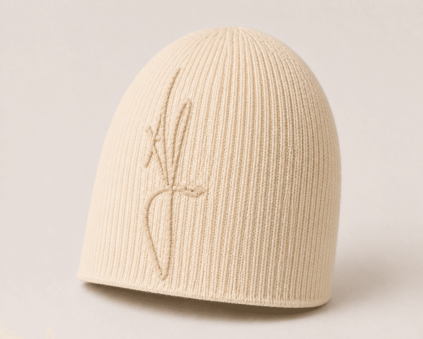 Nūr Signature Beanie in Bone, skully front three-quarter view