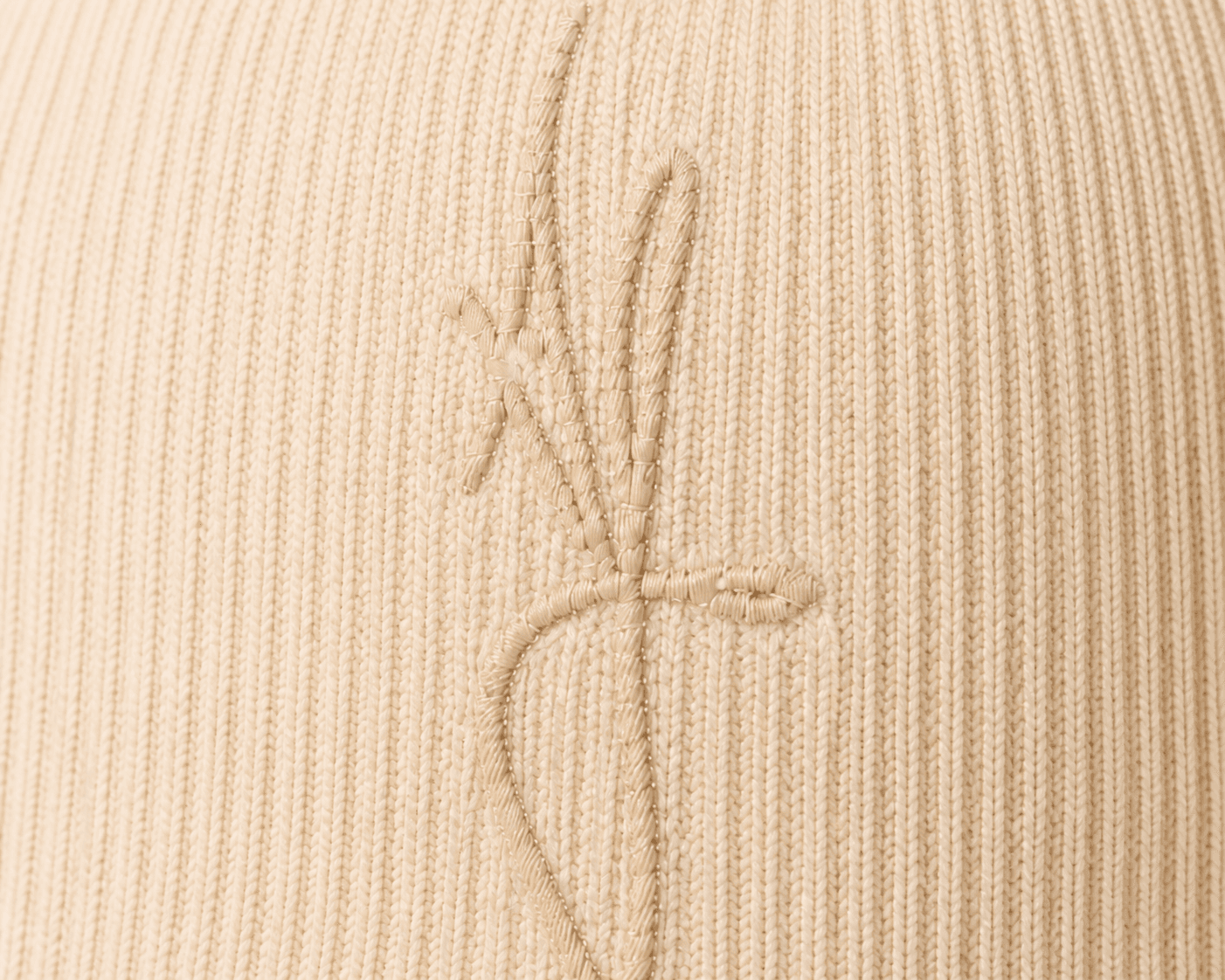 Nūr Signature Beanie in Bone, tonal almond-bone signature AF and rib detail