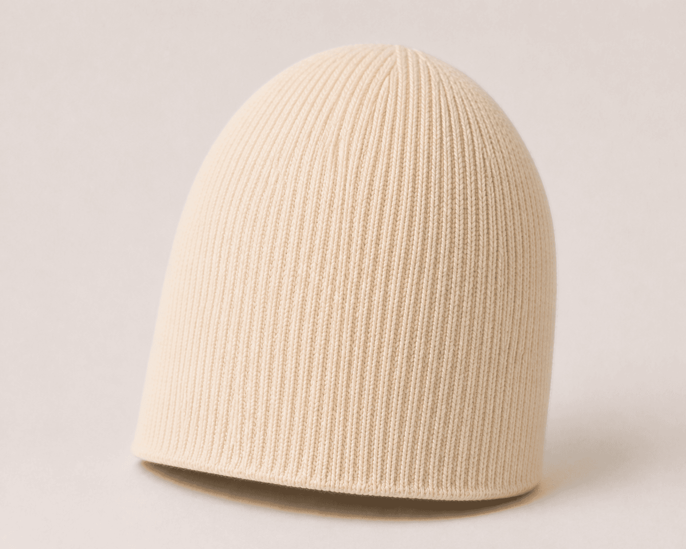 Nūr Signature Beanie in Bone, skully rear three-quarter view